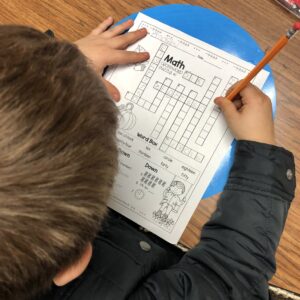 Student solving a Math Crossword Puzzle