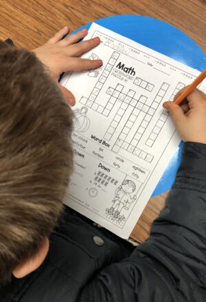 Student solving a Math Crossword Puzzle